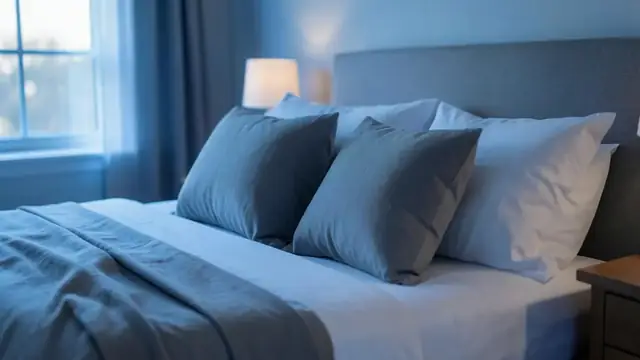 Neatly arranged pillows on a made bed in a calm bedroom