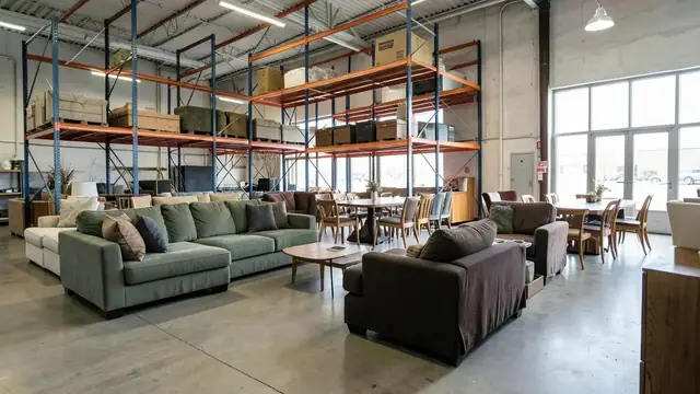 Sofas and dining sets displayed in a warehouse club furniture section