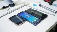 Refurbished smartphones on a workbench with tools